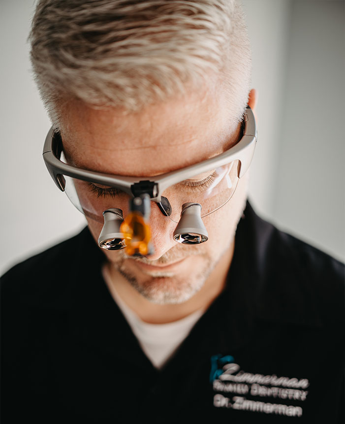 A man wearing glasses and a stethoscope, with a focus on his face and the equipment.