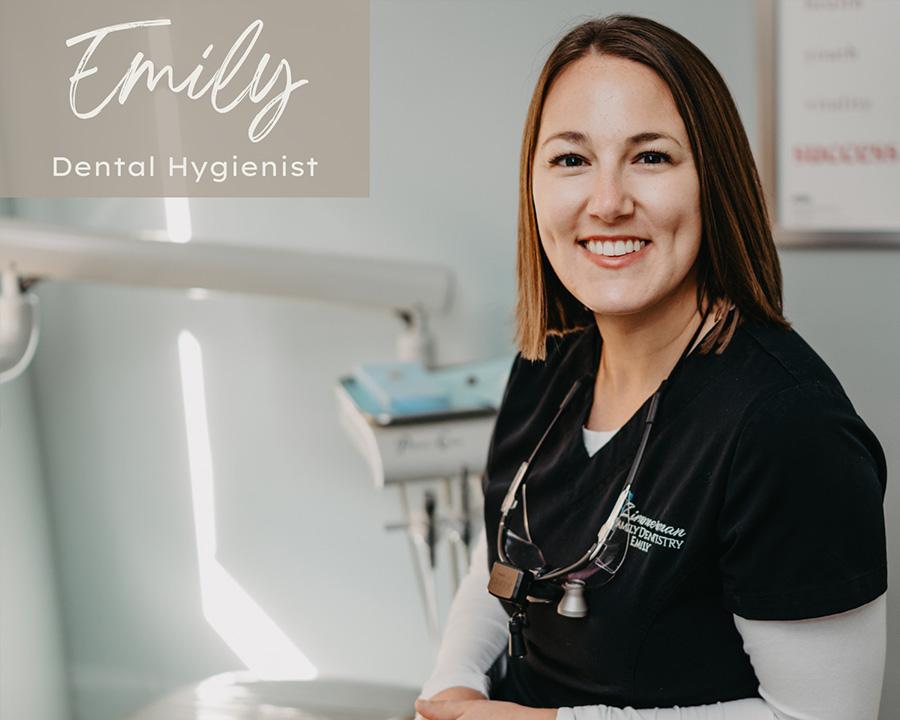 A dental hygienist in a professional setting, smiling at the camera.